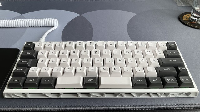 Photo of a 60% mechanical keyboard in a skeleton aluminum case called Holy60.
