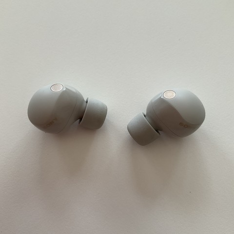 A photo of two gray Sony earbuds.