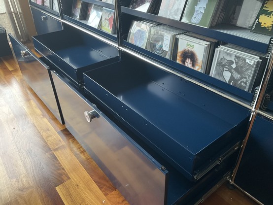Photo of a piece of USM furniture. Two drawers are open, revealing (newly installed) extension shelves.