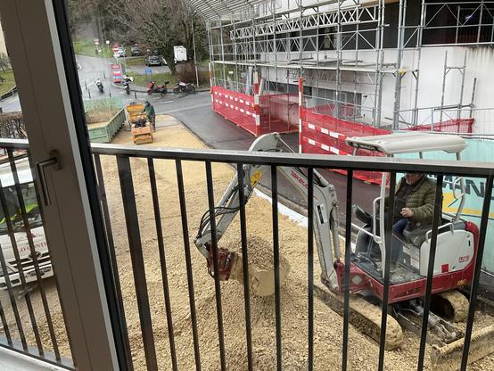 Various construction equipment in action outside of our living room.